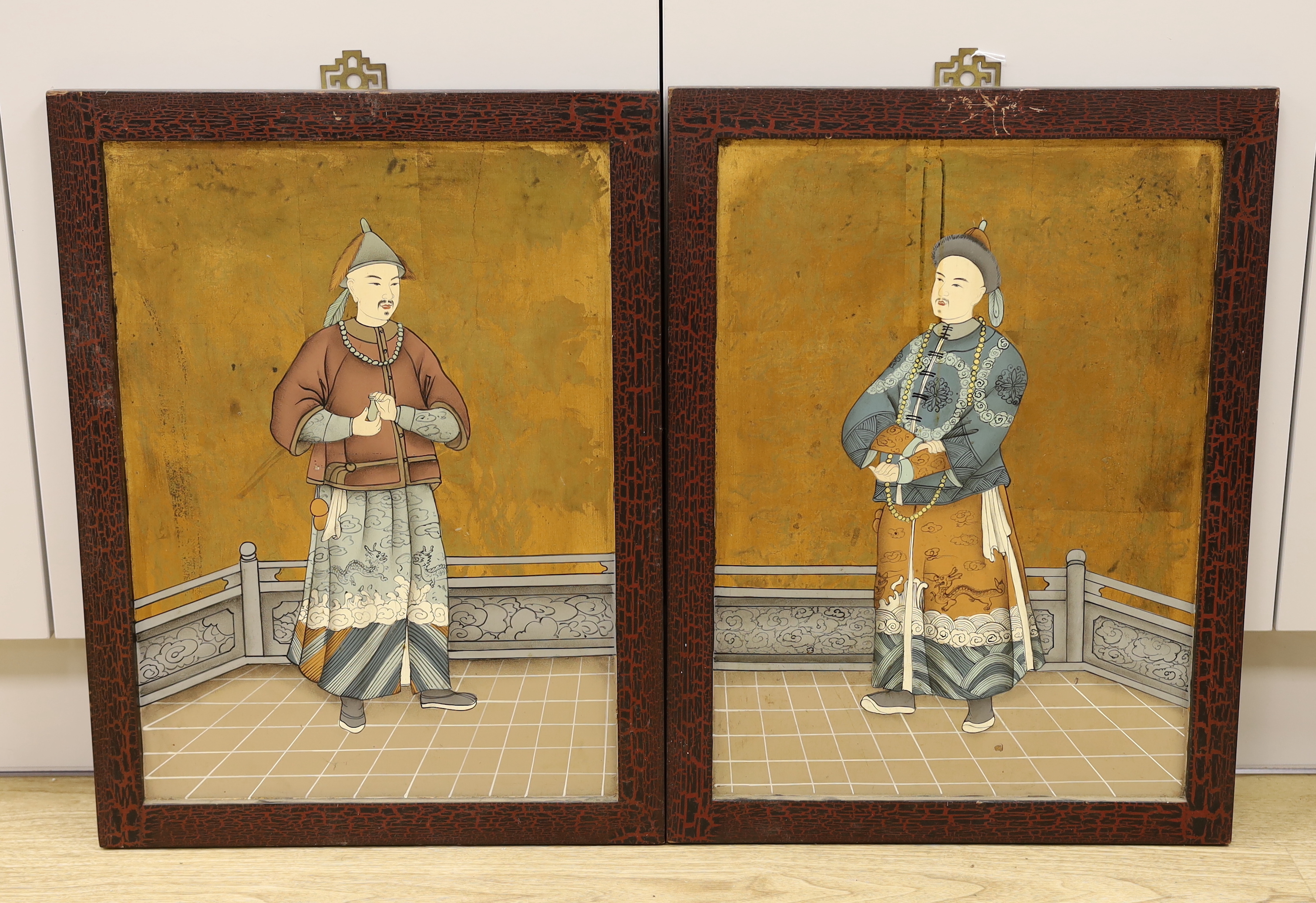 A pair of Chinese mandarin portraits on board, 38cm wide x 53cm high